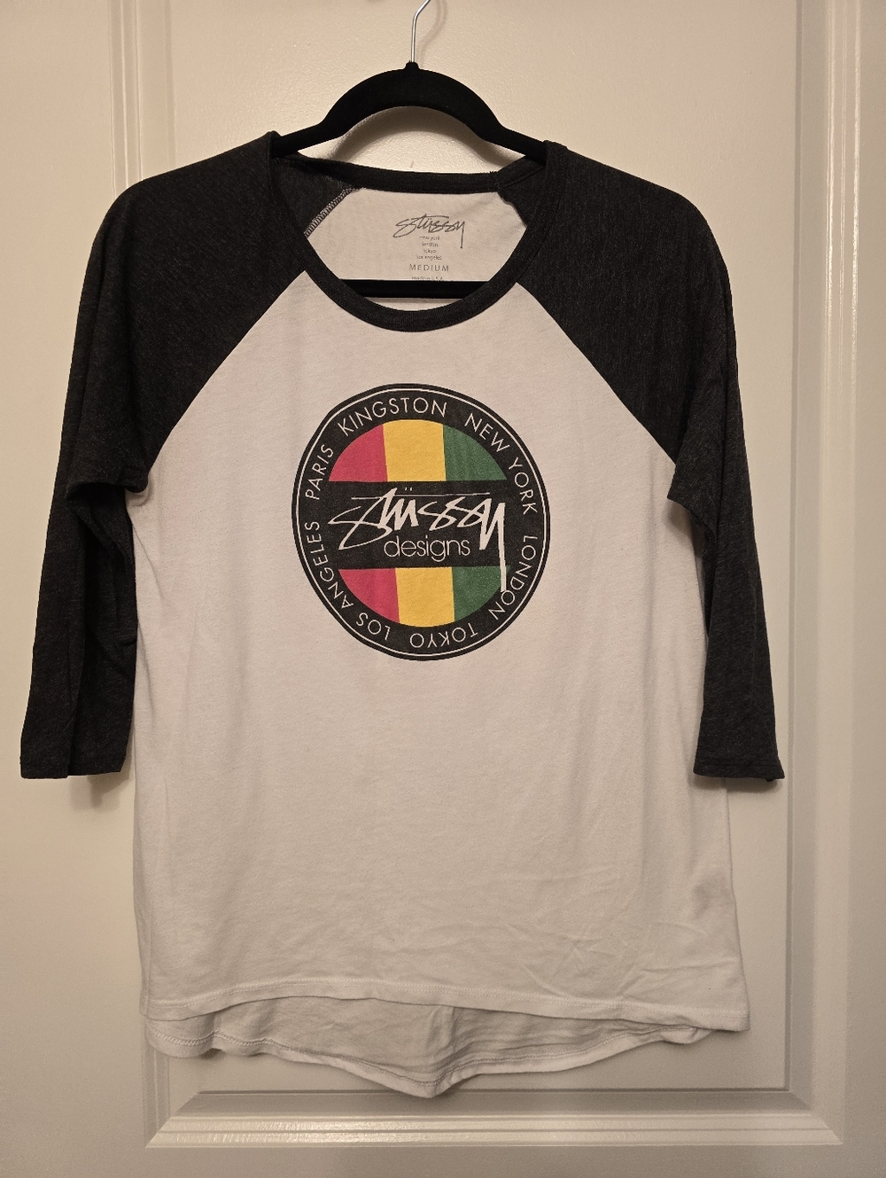 Stussy White Raglan Tee with Black Sleeves and Red/Yellow/Green Logo